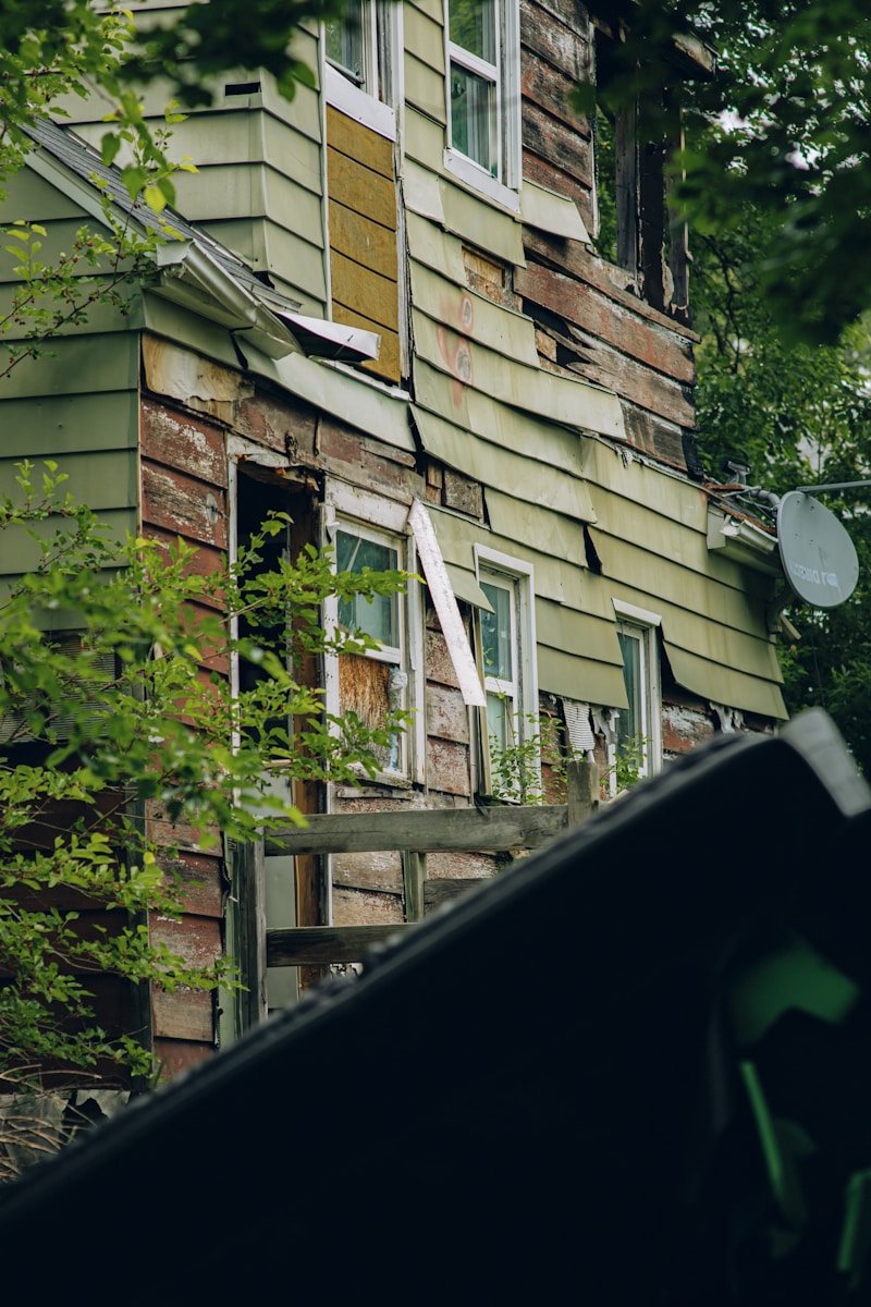 a run down house with a broken window